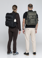 Two people wearing Black and Olive Cruiser backpacks, viewed from behind
