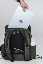 Laptop being placed into the Olive Cruiser's rear compartment, with a passport in its back pocket