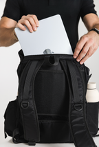 Laptop being placed in the Black Cruiser's rear laptop compartment