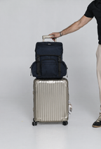 Deep Blue Cruiser on a rolling suitcase held by its handle