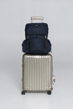 Deep Blue Cruiser resting on a silver rolling suitcase