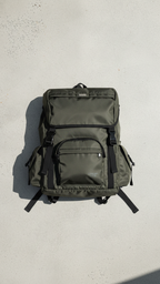 Olive Cruiser backpack against a light wall